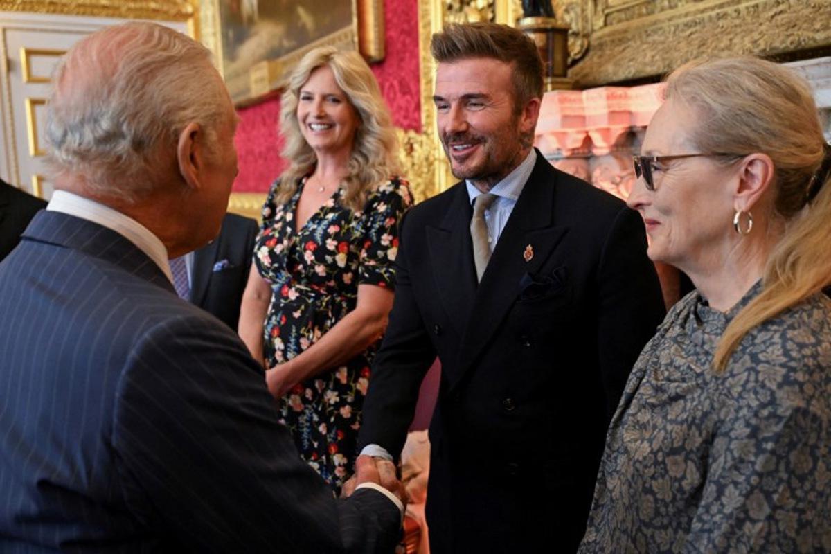 English former football player David Beckham (C) shakes hands with Britain's King Charles III (L) during the King's Foundation Awards ceremony, on the 35th anniversary of The King's Foundation, at St James's Palace, in London, on June 12, 2025. Chris J RATCLIFFE / POOL / AFP