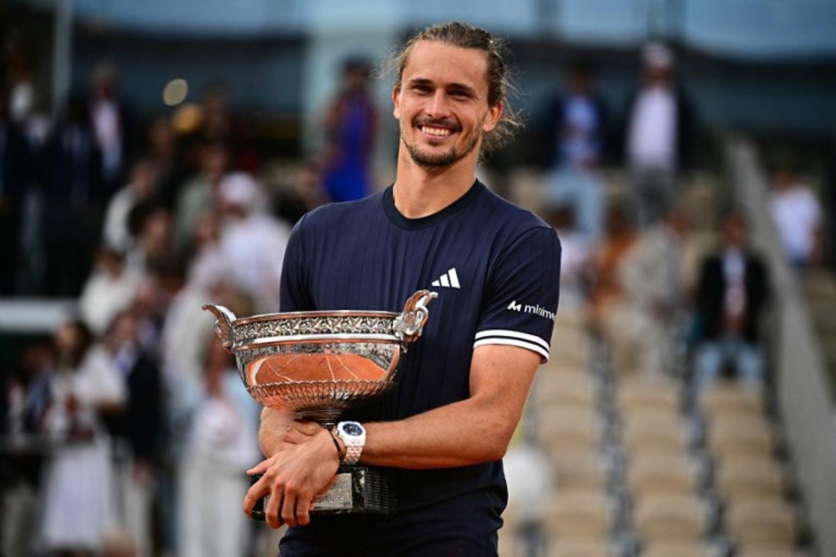 Germany's Alexander Zverev poses with "La Coupe des Mousquetaires" trophy after winning the French Open tennis tournament men's singles final match against Italy's Flavio Cobolli on day 15 of the French Open tennis tournament on Court Philippe-Chatrier at the Roland-Garros Complex in Paris on June 7, 2026. JULIEN DE ROSA / AFP
