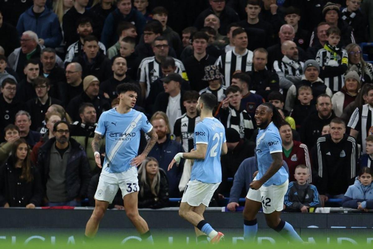 Manchester City's English midfielder #33 Nico O'Reilly (L) celebrates with temmates after scoring their second goal during the English Premier League football match between Manchester City and Newcastle at the Etihad Stadium in Manchester, north west England, on February 21, 2026. Darren Staples / AFP
