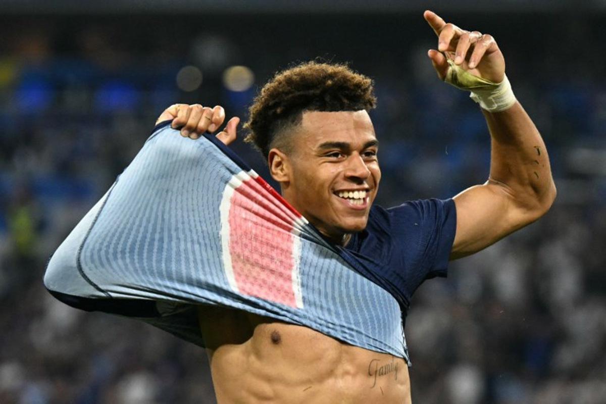 Paris Saint-Germain's French midfielder #14 Desire Doue removes his shirt as he celebrates after scoring PSG's third goal during the UEFA Champions League final football match between Paris Saint-Germain (PSG) and Inter Milan in Munich, southern Germany, on May 31, 2025. INA FASSBENDER / AFP