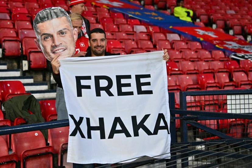 A fan of Switzerland's midfielder Granit Xhaka hlds up a banner in the crowd ahead of the UEFA Nations League, League B, Group 1 match football match between Scotland and Switzerland at Hampden Park in Glasgow, Scotland on September 29, 2026. ANDY BUCHANAN / AFP