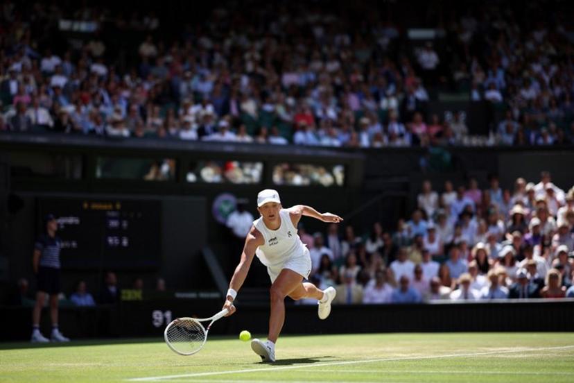 Poland's Iga Swiatek returns to Philippines' Alexandra Eala during their women's singles third round tennis match on the sixth day of the 2026 Wimbledon Championships at The All England Lawn Tennis and Croquet Club in Wimbledon, southwest London, on July 4, 2026. HENRY NICHOLLS / AFP
