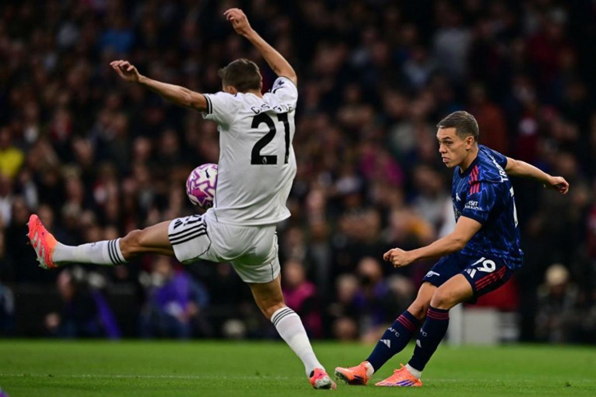 Arsenal's Belgian midfielder #19 Leandro Trossard (R) vies with Fulham's Belgian defender #21 Timothy Castagne (L) during the English Premier League football match between Fulham and Arsenal at Craven Cottage in London on October 18, 2025. Ben STANSALL / AFP