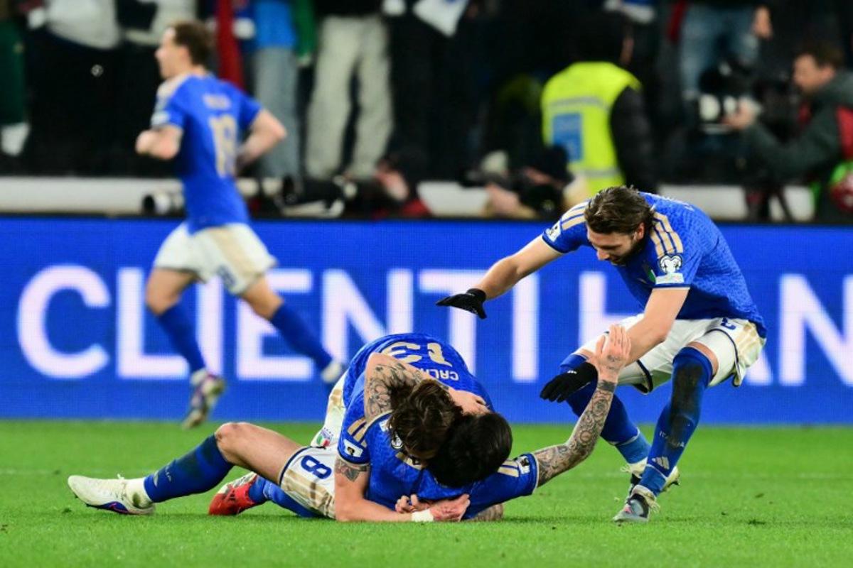 Italy's midfielder #08 Sandro Tonali, Italy's midfielder #13 Riccardo Calafiori celebrate the second goal during the play-off FIFA World Cup 2026 European qualification semi-final football match between Italy and North Ireland at the Gewiss stadium in Bergamo, on March 26, 2026. Stefano RELLANDINI / AFP