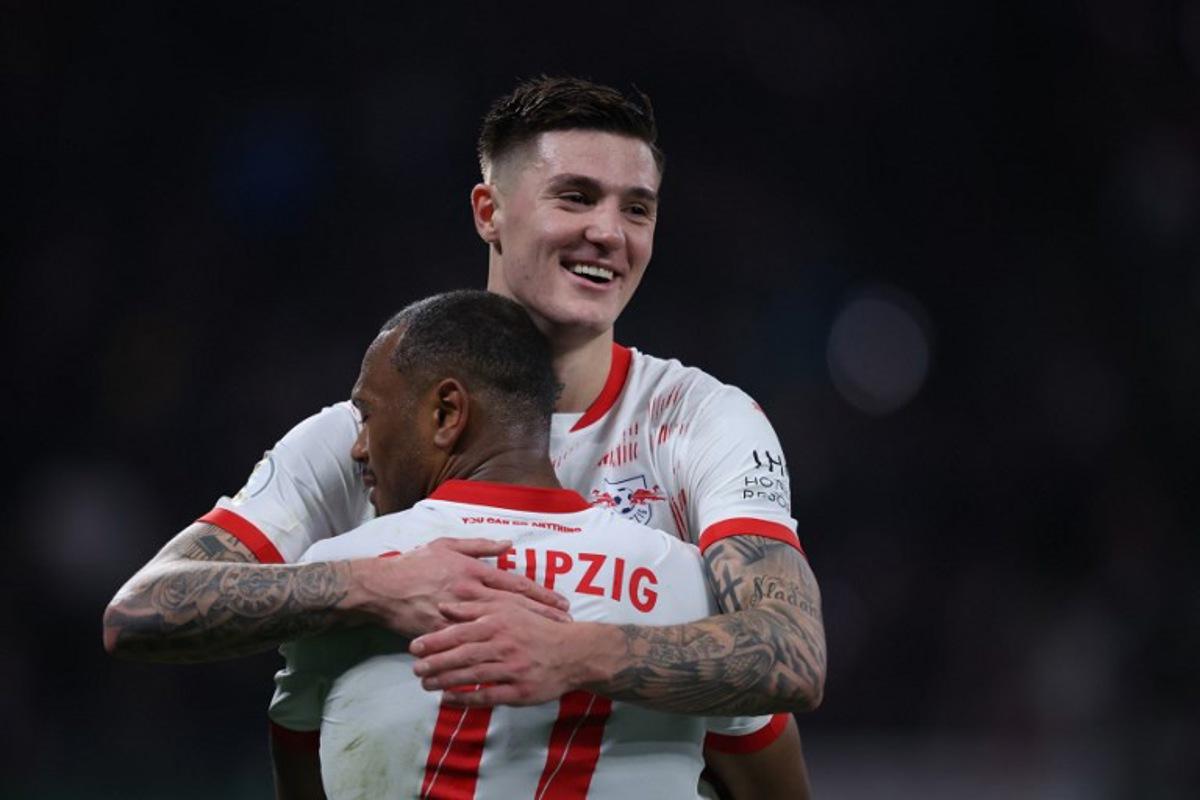 Leipzig's Belgian forward #11 Lois Openda (Front) and Leipzig's Slovenian forward #30 Benjamin Sesko celebrate after the German Cup (DFB Pokal) quarter final football match between RB Leipzig and VfL Wolfsburg in Leipzig, eastern Germany, on February 26, 2025. Ronny HARTMANN / AFP
