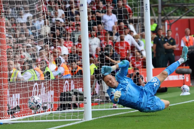 Nottingham Forest's Belgian goalkeeper #26 Matz Sels fails to stop a shot from Leeds United's German midfielder #18 Anton Stach as Leeds score a late winner during the English Premier League football match between Nottingham Forest and Leeds United at The City Ground in Nottingham, central England, on August 22, 2026. Darren Staples / AFP