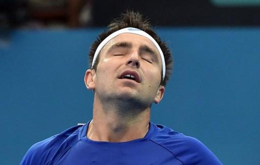 Marinko Matosevic of Australia reacts while playing against Steve Johnson of the US during their men's singles match on day three of the Brisbane International tennis tournament in Brisbane on January 6, 2015. AFP PHOTO / Saeed KHAN IMAGE RESTRICTED TO EDITORIAL USE - STRICTLY NO COMMERCIAL USE IMAGE RESTRICTED TO EDITORIAL USE - STRICTLY NO COMMERCIAL USE