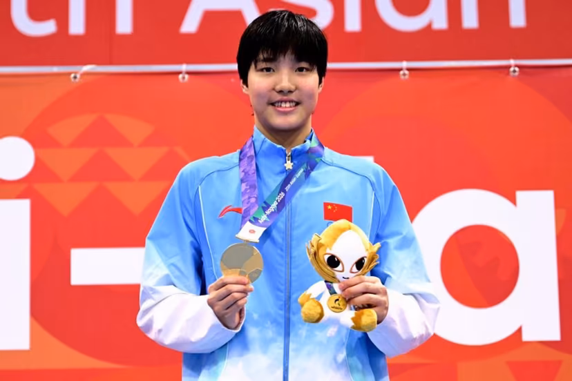 Gold medallist China's Yu Zidi celebrates on the podium during the victory ceremony of the women's 200m butterfly swimming event during the 2026 Asian Games at the Tokyo Aquatics Centre in Tokyo on September 20, 2026. Yuichi YAMAZAKI / AFP