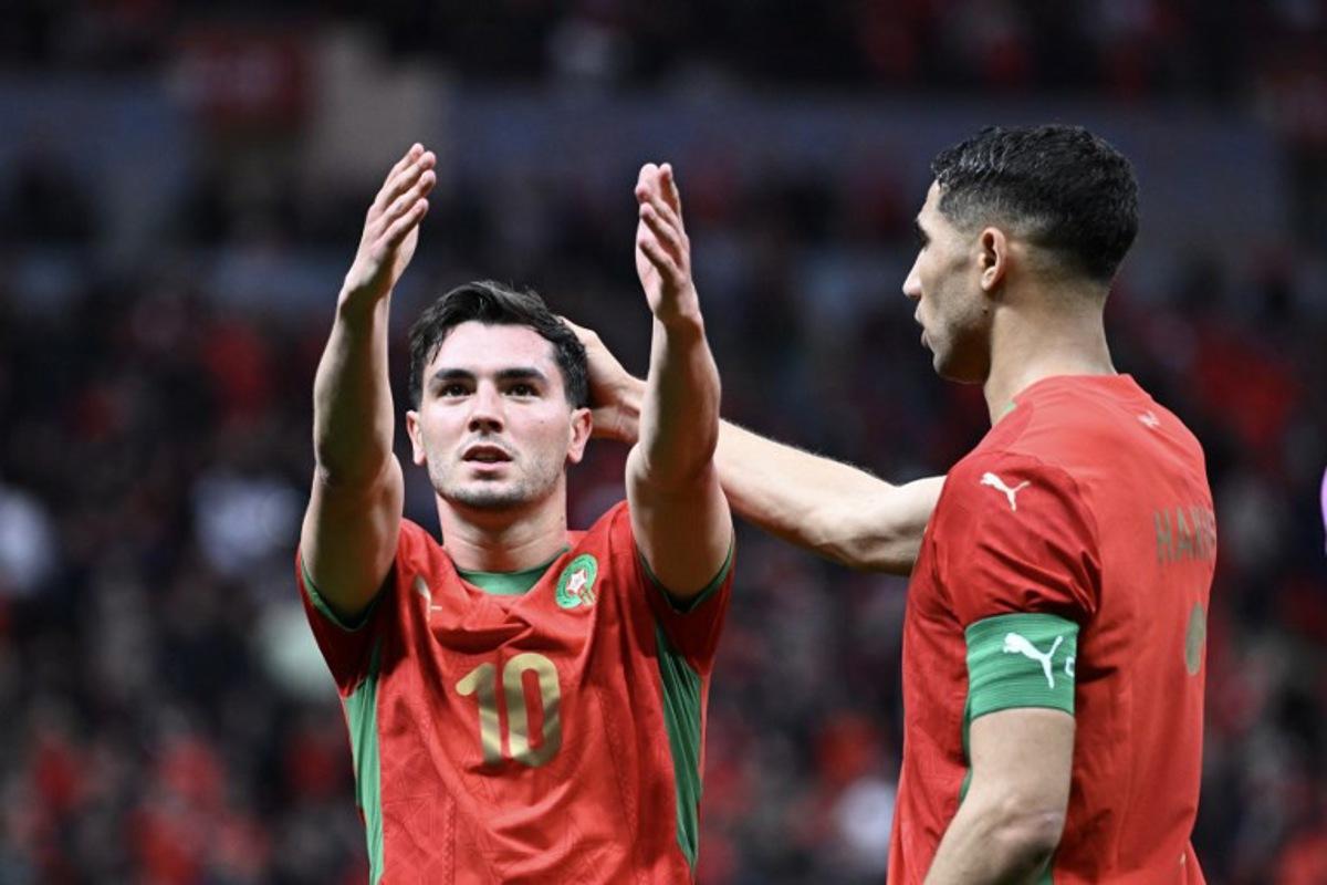 Morocco's forward #10 Brahim Diaz celebrates scoring his team's first goal next to Morocco's defender #02 Achraf Hakimi during the Africa Cup of Nations (CAN) round of 16 football match between Morocco and Tanzania at Prince Moulay Abdallah Stadium in Rabat on January 4, 2026. SEBASTIEN BOZON / AFP
