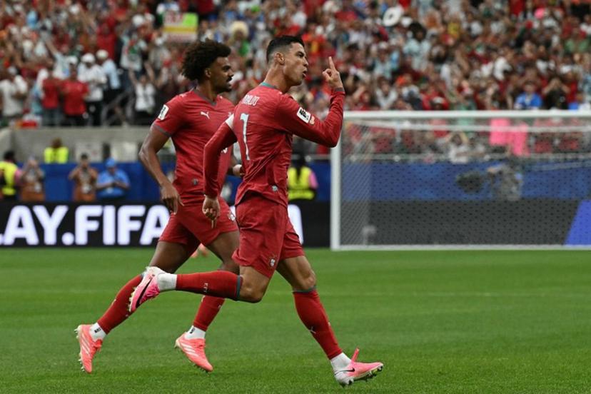 Portugal's forward #07 Cristiano Ronaldo (R) celebrates after scoring the opening goal during the 2026 World Cup Group K football match between Portugal and Uzbekistan at the Houston Stadium in Houston on June 23, 2026. RONALDO SCHEMIDT / AFP