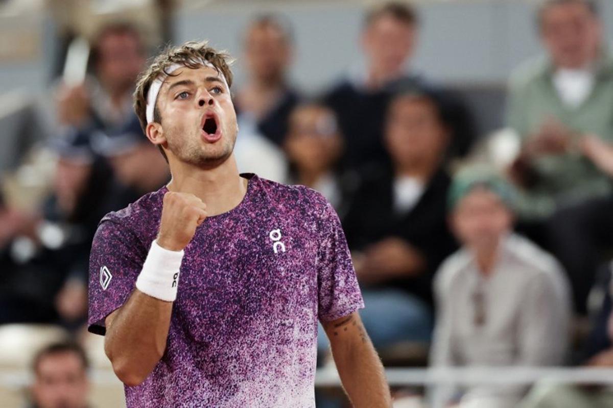 Italy's Flavio Cobolli reacts after a point as he plays against Canada's Felix Auger-Aliassime during their men's quarter final singles match on day 11 of the French Open tennis tournament on Court Philippe-Chatrier at the Roland-Garros Complex in Paris on June 3, 2026. ALAIN JOCARD / AFP