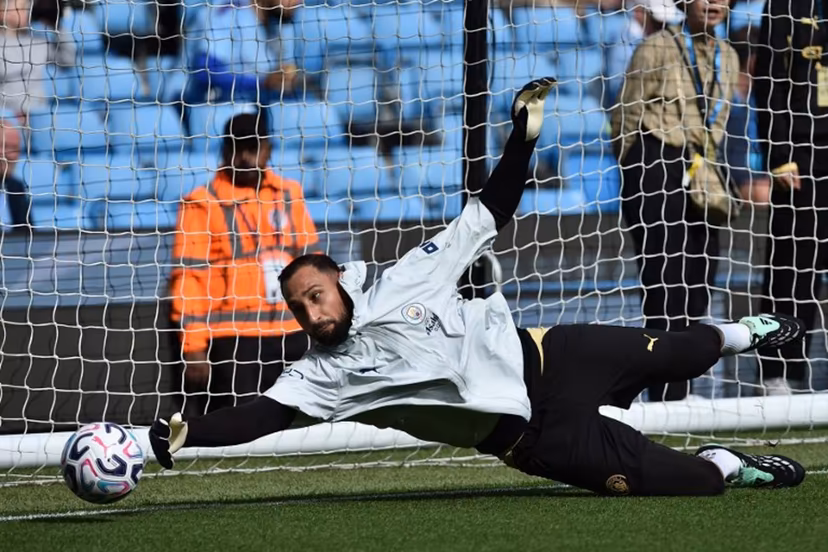 Manchester City's Italian goalkeeper #01 Gianluigi Donnarumma warms up ahead of the English Premier League football match between Manchester City and Sunderland at the Etihad Stadium in Manchester, north west England, on September 20, 2026. PETER POWELL / AFP