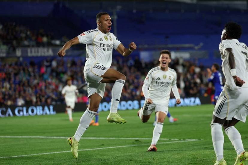Real Madrid's French forward #10 Kylian Mbappe celebrates scoring his team's first goal during the Spanish league football match between Getafe CF and Real Madrid CF at Coliseum Alfonso Perez Stadium in Getafe on October 19, 2025. Thomas COEX / AFP
