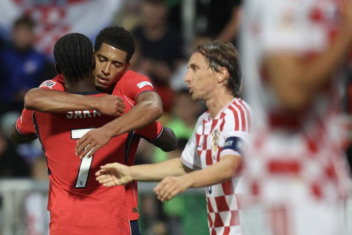 England's midfielder #10 Jude Bellingham celebrates with teammate England's forward #7 Bukayo Saka after he scored England's fourth goal, as Croatia's midfielder #10 Luka Modric (R) reacts during the UEFA Nations League, league A day 3: Group 3, football match between Croatia and England at the Stadion HNK Rijeka stadium in Rijeka, Croatia, on October 3, 2026. MARKO PERKOV / AFP
