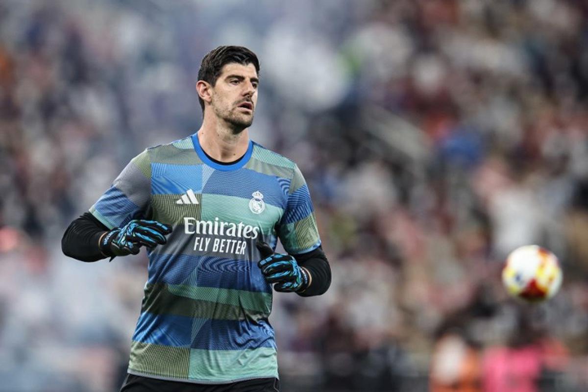 Real Madrid's Belgian goalkeeper #01 Thibaut Courtois warms up prior to the start of the Spanish Super Cup final football match between FC Barcelona and Real Madrid at the King Abdullah Stadium in Jeddah on January 11, 2026. Fadel SENNA / AFP