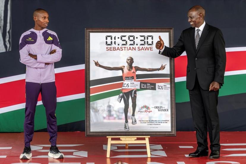 Kenya's President William Ruto (R) gives a thumbs-up as he congratulates Kenyan marathon runner Sabastian Sawe (L) during a ceremony at State House in Nairobi, on April 30, 2026, after breaking a historic world record at the London Marathon. Sabastian Sawe became the first man to run under two hours for a marathon in race conditions thanks to extraordinary talent, a punishing training regime, and the lightest shoes in history. In London on April 26, 2026, the 31-year-old Kenyan achieved one of sport's milestones, ranking alongside Roger Bannister's first sub-four minute mile in 1954. Luis TATO / AFP