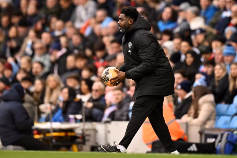 Manchester City's Ivorian assistant coach Kolo Touré holds the ball during the English FA Cup third round football match between Manchester City and Salford City at the Etihad Stadium in Manchester, north west England, on February 14, 2026. Oli SCARFF / AFP