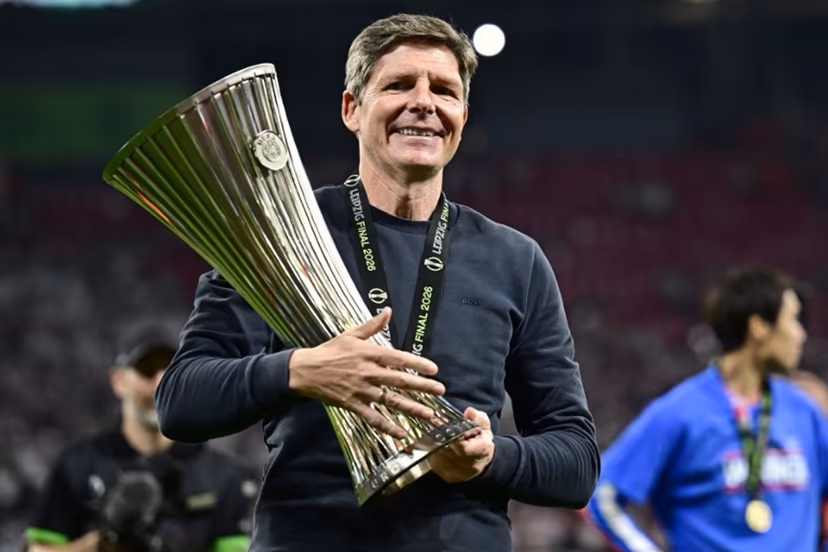 Crystal Palace's Austrian manager Oliver Glasner reacts as he holds the trophy after his team won the UEFA Conference League final football match between Crystal Palace FC and Rayo Vallecano de Madrid in Leipzig, eastern Germany, on May 27, 2026. Tobias SCHWARZ / AFP