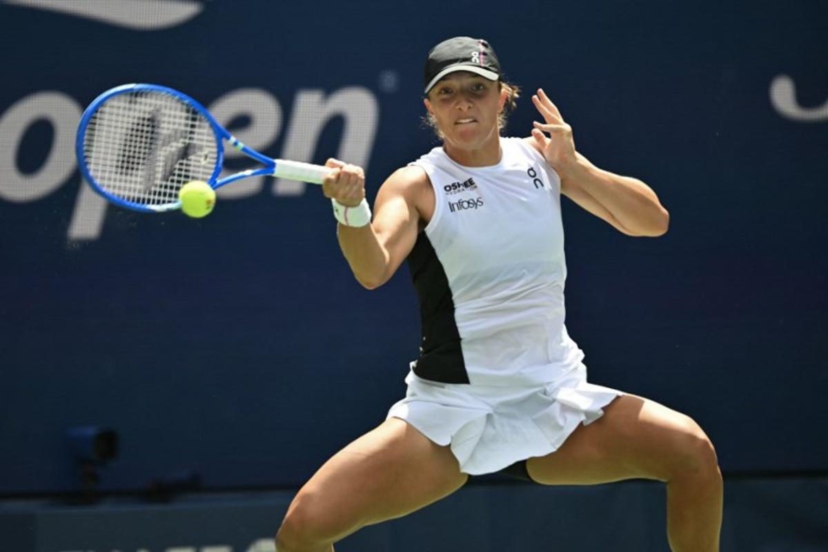 Poland's Iga Swiatek plays a forehand return to Russia's Ekaterina Alexandrova during their women's singles round of 16 tennis match on day nine of the US Open tennis tournament at the USTA Billie Jean King National Tennis Center in New York City, on September 1, 2025. ANGELA WEISS / AFP