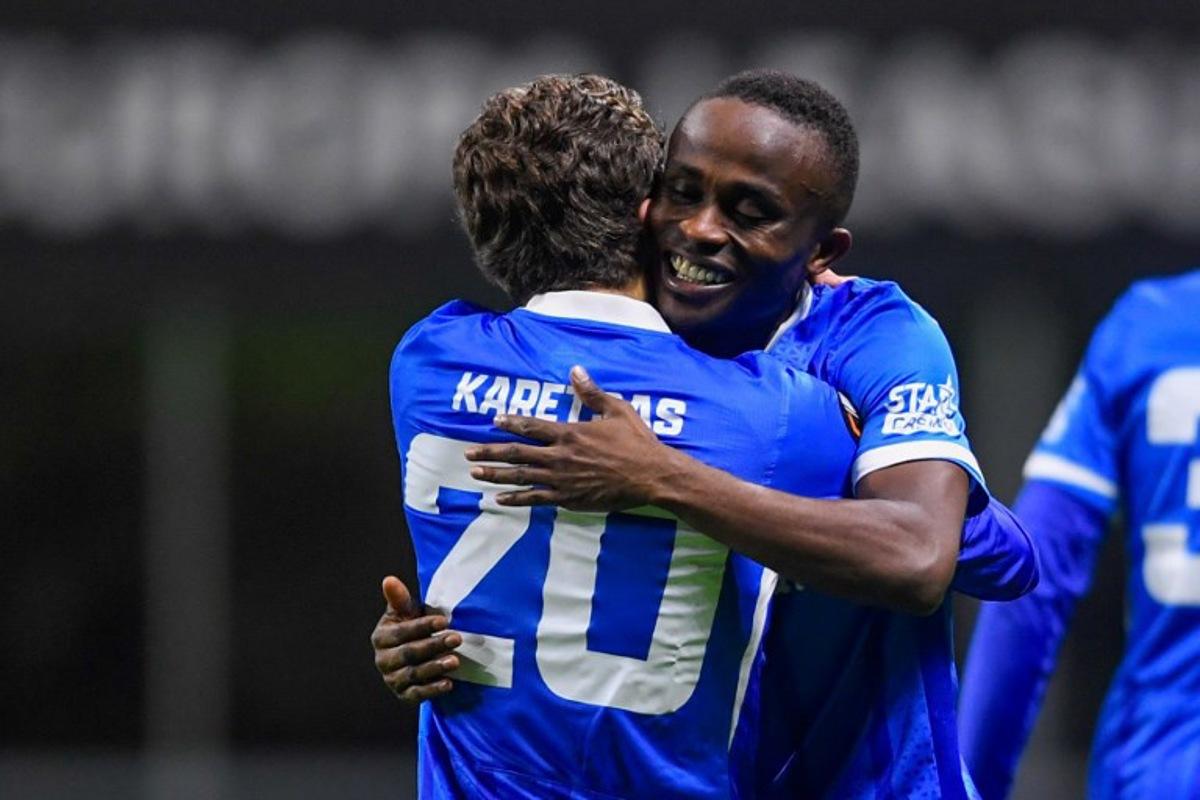 RC Genk's Nigerian forward #14 Yira Sor (R) celebrates with teammate RC Genk's Greek midfielder #20 Konstantinos Karetsas after scoring their second goal during the Europa League 1st round day 4 football match between SC Braga and RC Genk at the Municipal stadium of Braga on November 6, 2025. MIGUEL LEMOS / AFP