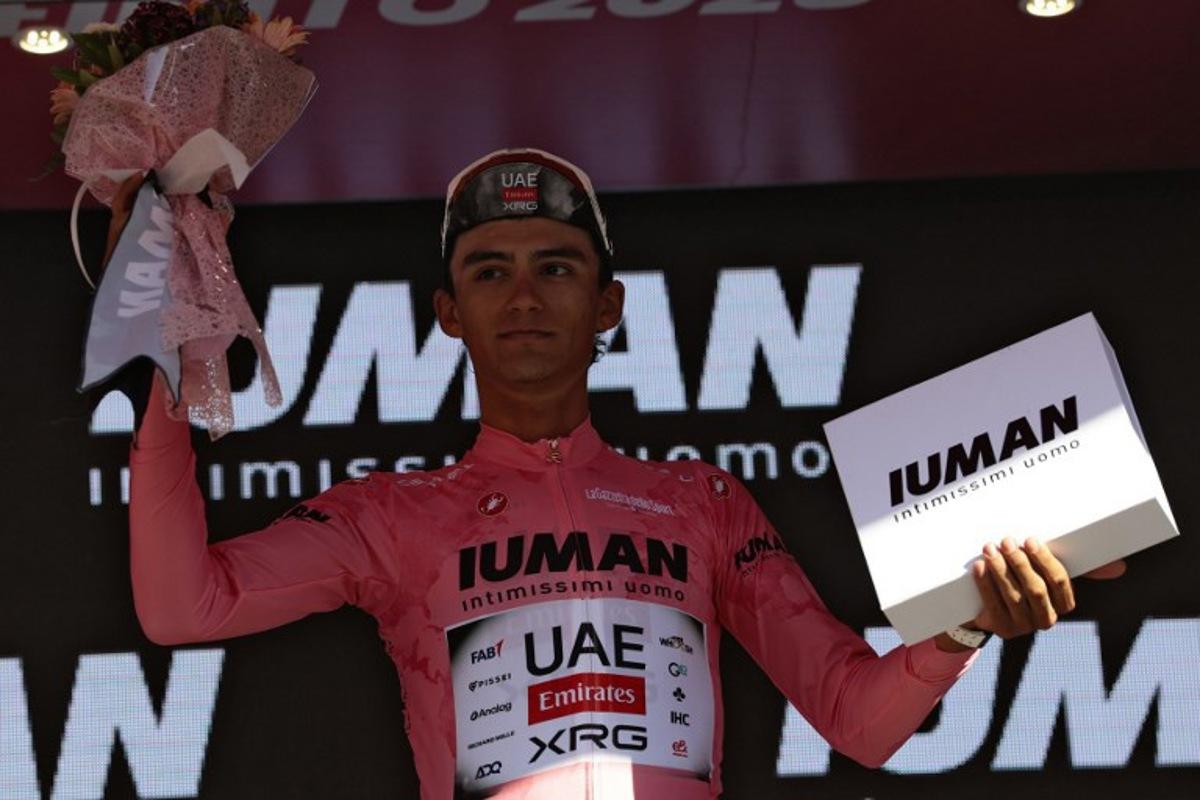 UAE Team Emirates XRG's Mexican rider Isaac Del Toro celebrates with the pink jersey of overall leader on the podium of the 9th stage of the 108th Giro d'Italia cycling race of 181kms from Gubbio to Siena on May 18, 2025. Luca Bettini / AFP