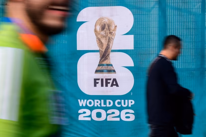 Pedestrians walk past an official competition logo on a fence ahead of the 2026 World Cup Group A football match between Mexico and South Africa at the Mexico City Stadium in Mexico City on June 11, 2026. Rodrigo Oropeza / AFP