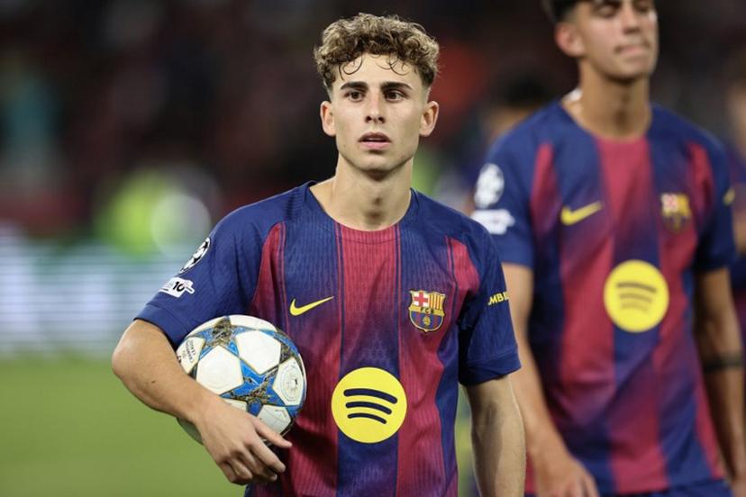 Barcelona's Spanish midfielder #16 Fermin Lopez carries the ball after scoring three goals for a hat trick in the UEFA Champions League league phase match-day 3 football match between FC Barcelona and Olympiakos FC at Estadi Olimpic Lluis Companys in Barcelona on October 21, 2025. Barcelona won 6-1. Josep LAGO / AFP