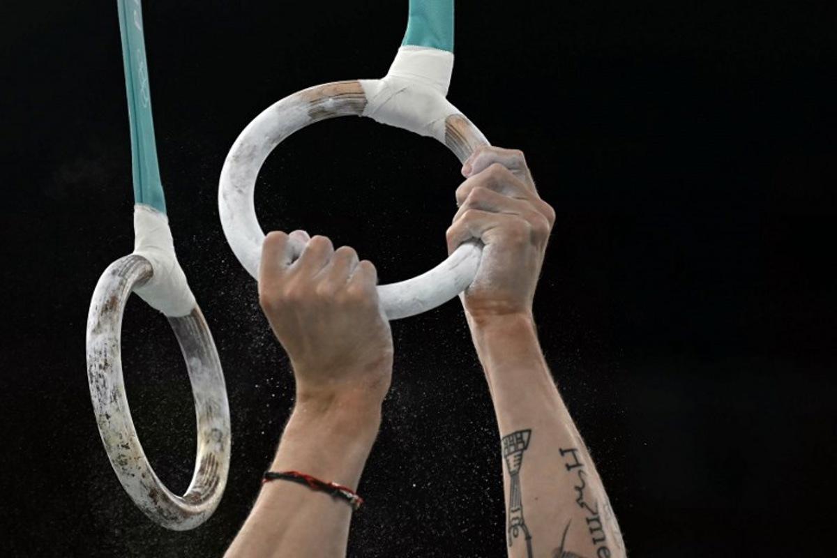 Ukraine's Illia Kovtun gets ready to compete in the rings event of the artistic gymnastics men's team final during the Paris 2024 Olympic Games at the Bercy Arena in Paris, on July 29, 2024. Paul ELLIS / AFP