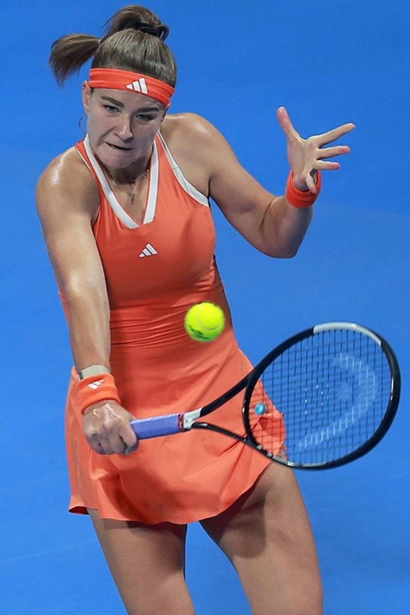 Czech Republic's Karolina Muchova hits a return to Canada's Victoria Mboko during their women's singles final match at the Qatar Open tennis tournament in Doha on February 14, 2026. Karim JAAFAR / AFP