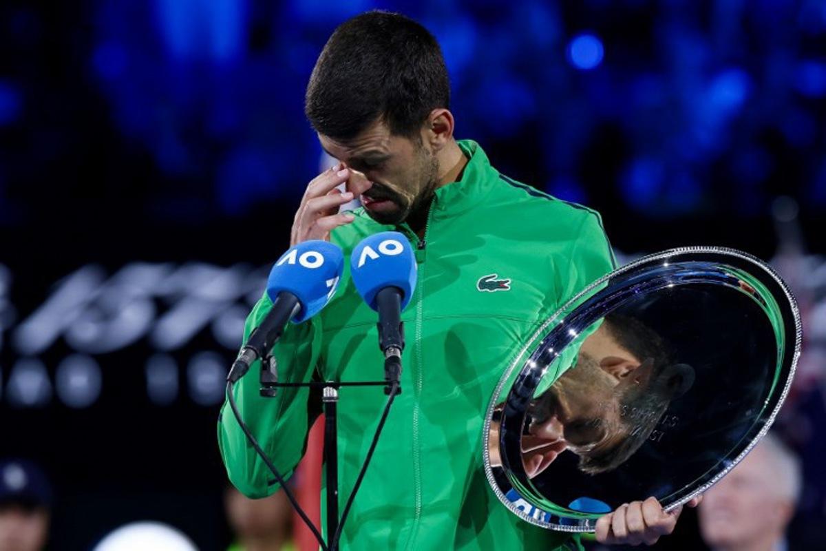 Serbia's Novak Djokovic speaks after receiving the runner-up shield following his defeat to Spain's Carlos Alcaraz in the men's singles final on Day 15 of the Australian Open. tennis tournament in Melbourne on February 1, 2026. IZHAR KHAN / AFP