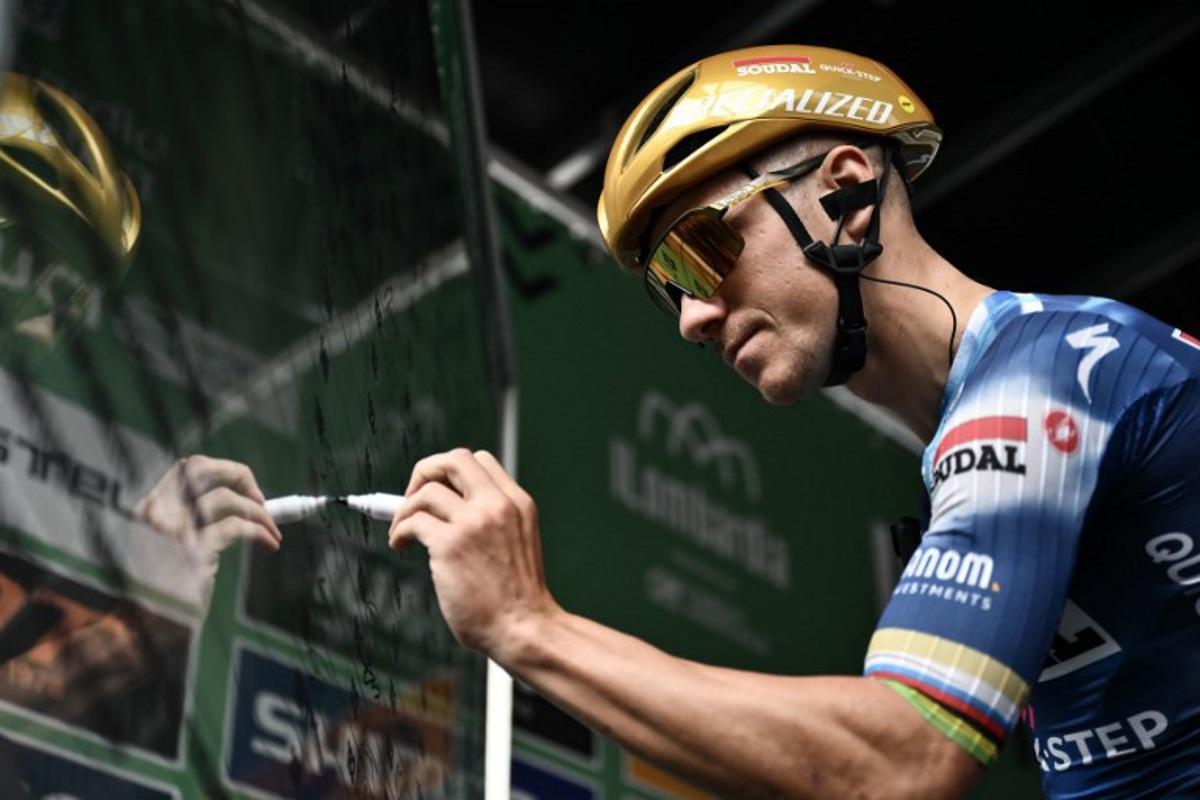 Soudal Quick-Step's Belgian rider Remco Evenepoel signs in, ahead of the 119th edition of the Giro di Lombardia (Tour of Lombardy), a 238km cycling race from Como to Bergamo on October 11, 2025. Marco BERTORELLO / AFP