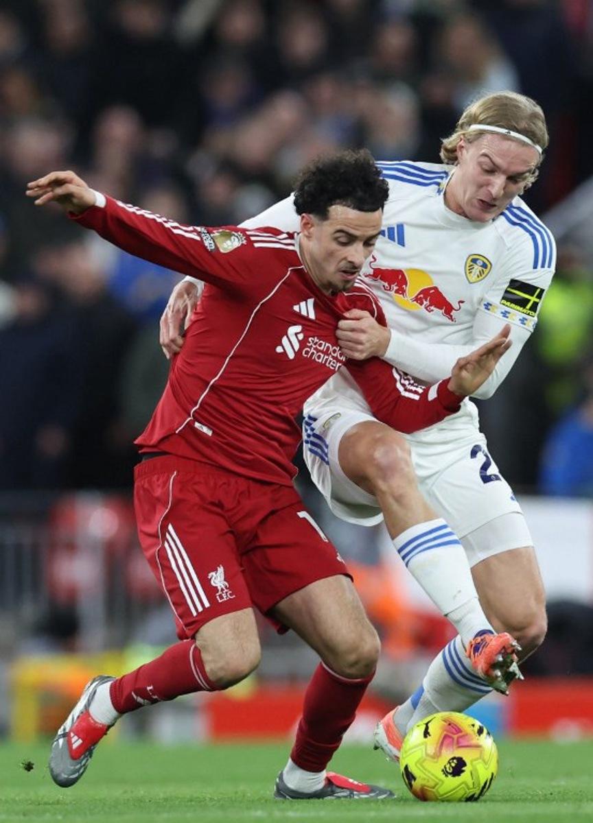Leeds United's Belgian defender #23 Sebastiaan Bornauw (R) tries to tackle Liverpool's English midfielder #17 Curtis Jones (L) during the English Premier League football match between Liverpool and Leeds United at Anfield in Liverpool, north west England on January 1, 2026. Darren Staples / AFP