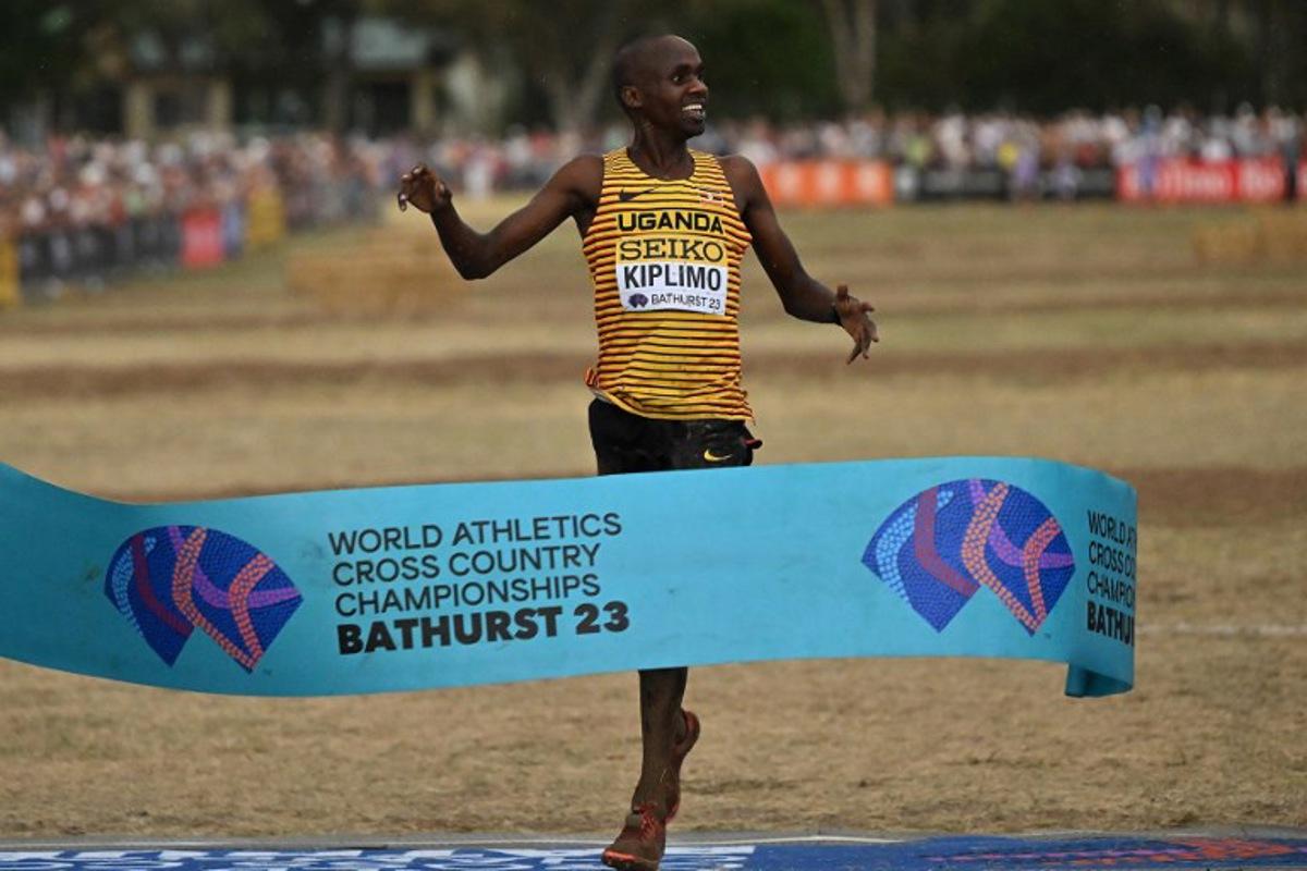 Uganda's Jacob Kiplimo celebrates as he crosses the finish line to win the men's senior race during the 2023 World Cross Country Championships at Mount Panorama in Bathurst on February 18, 2023. Saeed KHAN / AFP