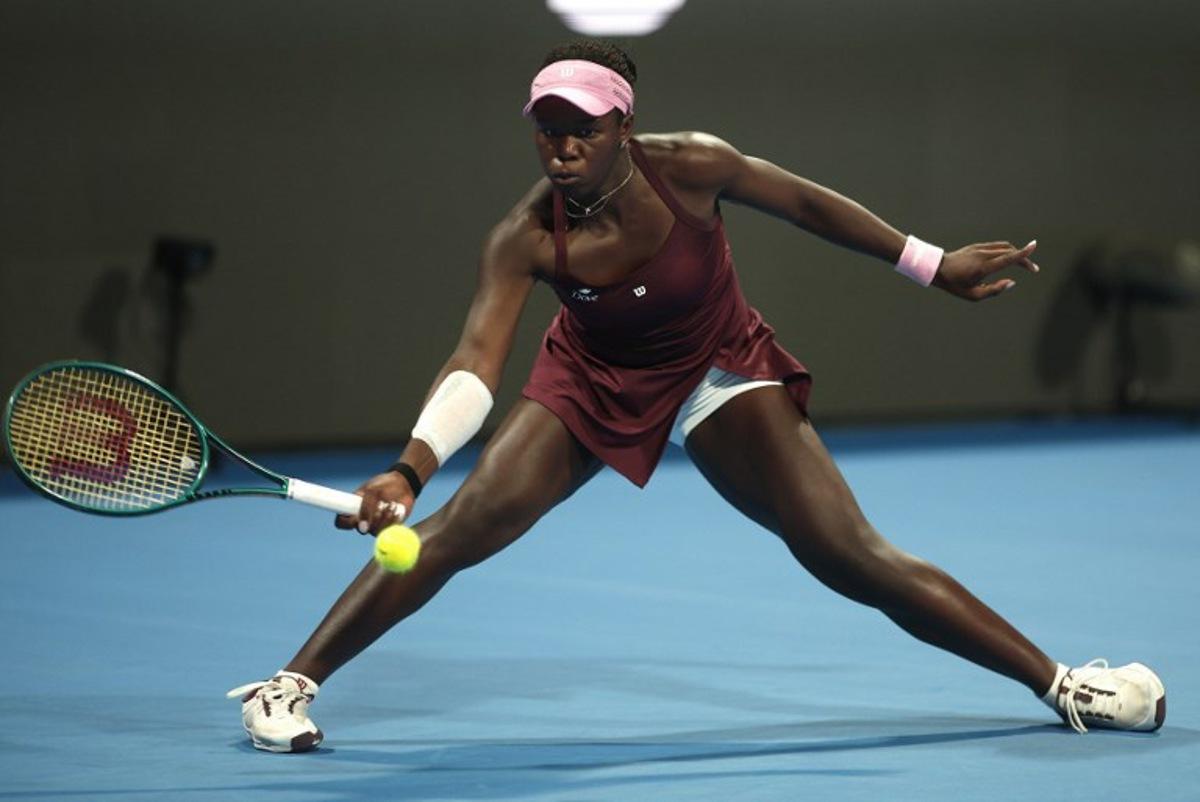 Canada's Victoria Mboko hits a return to Latvia's Jelena Ostapenko during their women's singles semi-final match at the Qatar Open tennis tournament in Doha on February 13, 2026. Karim JAAFAR / AFP