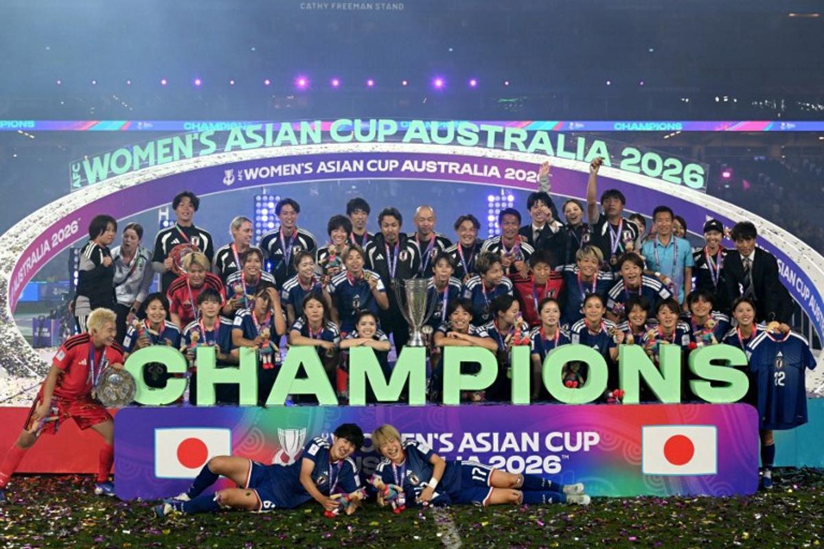 Japan's team celebrate with the trophy after winning the final of the AFC Women's Asian Cup Australia 2026 football tournament between Australia and Japan at Stadium Australia in Sydney on March 21, 2026. Saeed Khan / AFP