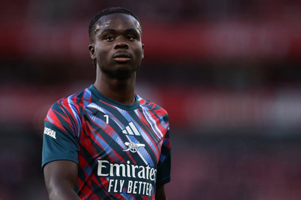 Arsenal's English midfielder #07 Bukayo Saka warms up ahead of the English Premier League football match between Arsenal and Coventry City at the Emirates Stadium in London on August 21, 2026. Henry NICHOLLS / AFP