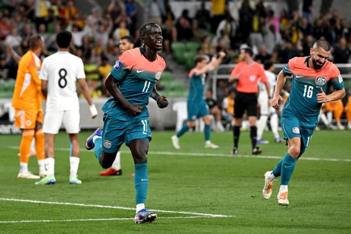 Australia's Awer Mabil (C) celebrates after scoring a goal during the international friendly football match between Australia and Curacao at the Melbourne Rectangular Stadium in Melbourne on March 31, 2026. WILLIAM WEST / AFP