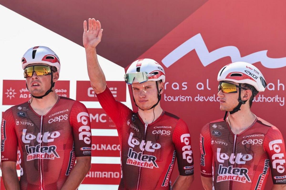 Lotto Intermarché's Belgian rider Lennert Van Eetvelt (C) waves ahead of the third stage of the UAE Tour cycling event from Umm al-Quwain to Jebel Mobrah in Umm al-Quwain on February 18, 2026. Fadel SENNA / AFP