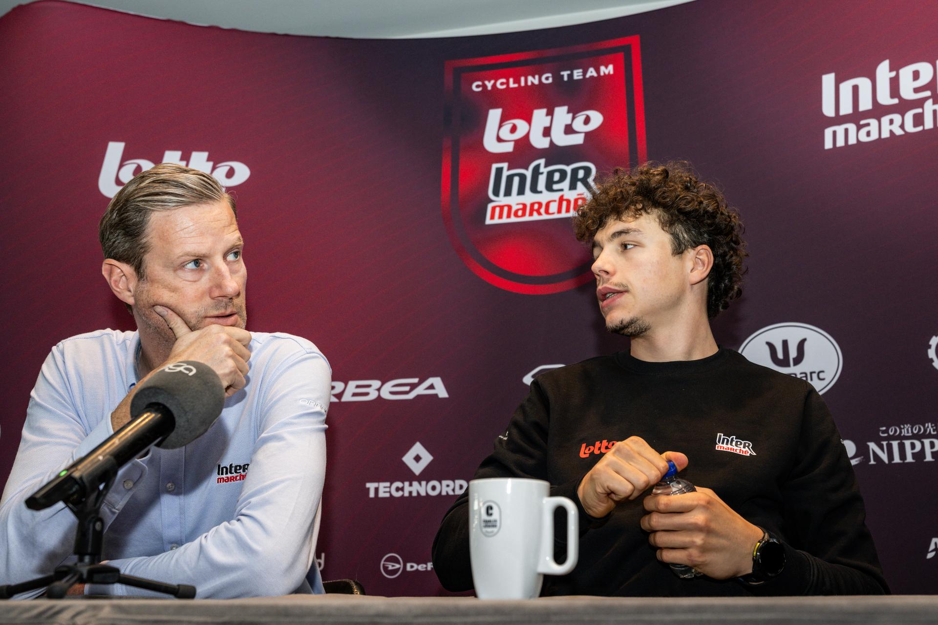 performance manager Dutch Aike Visbeek and Belgian Arnaud De Lie of Lotto-Intermarche pictured during a press conference of the Lotto-Intermarche cycling team, to discuss this weekend's one-day cycling race Omloop Het Nieuwsblad, the opening race of the Flemish classic one day races season, Thursday 26 February 2026 in Sint-Martens-Latem. BELGA PHOTO DAVID PINTENS