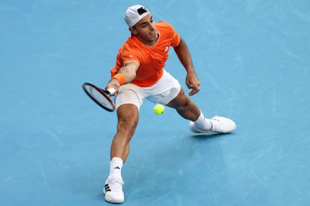 Argentina's Francisco Cerundolo hits a shot against Germany's Alexander Zverev during their men's singles match on day eight of the Australian Open tennis tournament in Melbourne on January 25, 2026. IZHAR KHAN / AFP