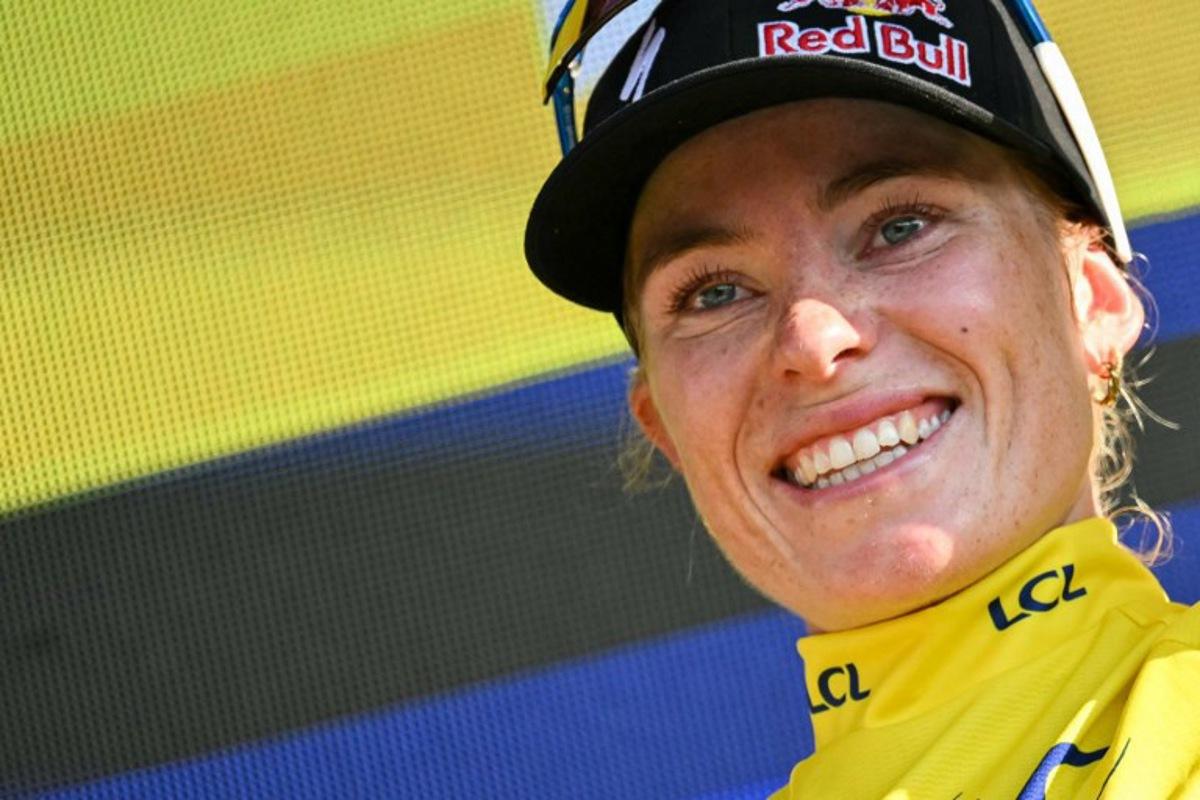 FDJ-SUEZ's Dutch rider Demi Vollering celebrates on the podium wearing the overall leader's yellow jersey after the 8th (out of 9) stage of the fifth edition of the Women's Tour de France cycling race, 171.9 km from Sisteron to Nice, in Nice, southeastern France on August 8, 2026. NICOLAS TUCAT / AFP