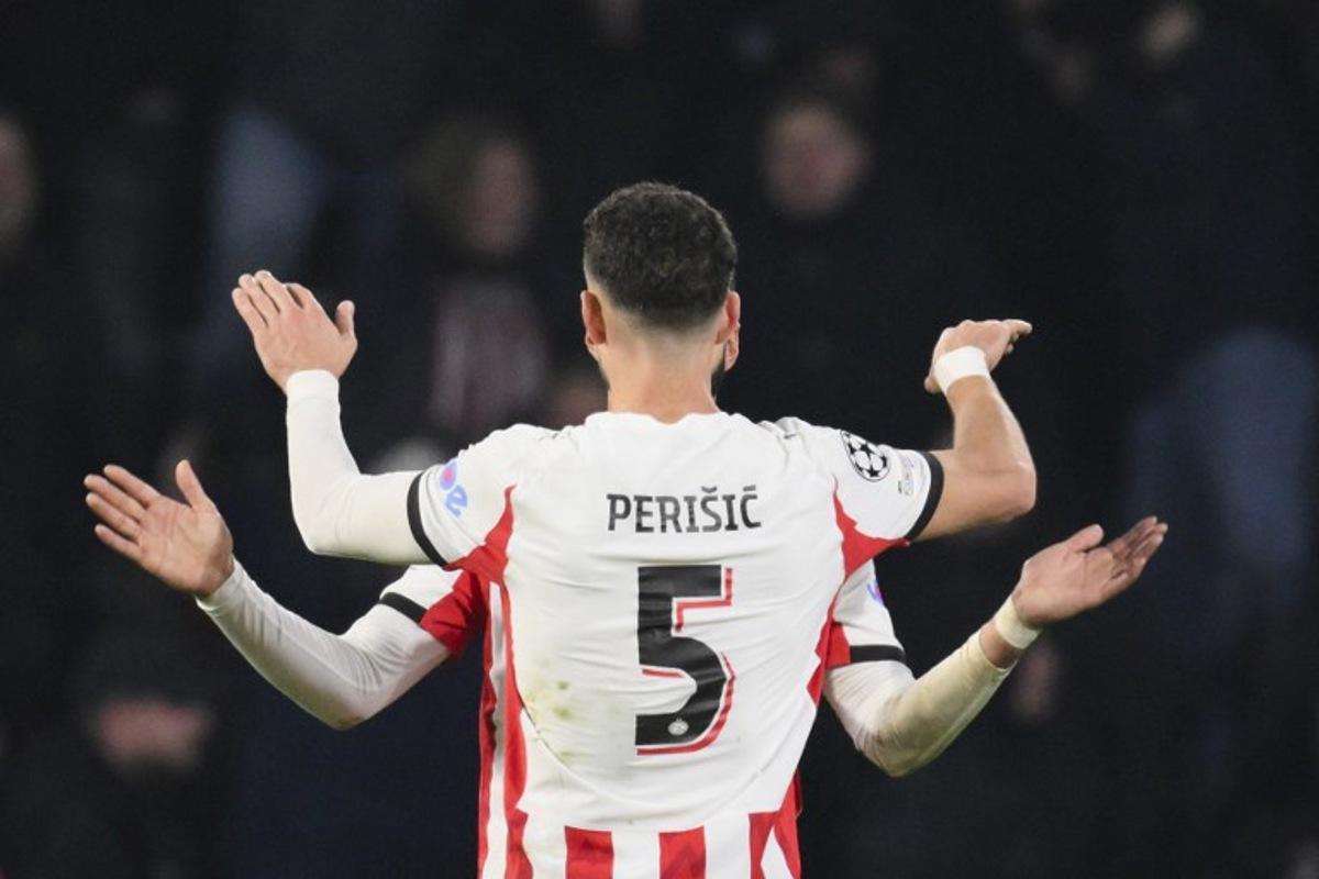 PSV Eindhoven's Moroccan midfielder #34 Ismael Saibari (unseen) celebrates with PSV Eindhoven's Croatian forward #05 Ivan Perisic after scoring his team's first goal during the UEFA Champions League league phase day 8 football match between PSV Eindhoven and Bayern Munich at Philips Stadion in Eindhoven on January 28, 2026. JOHN THYS / AFP