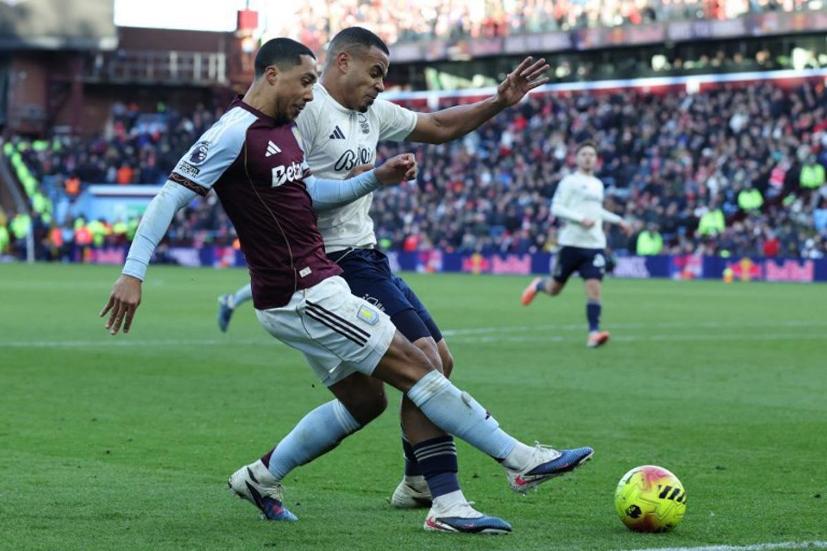 Aston Villa's Belgian midfielder #08 Youri Tielemans (L) vies with Nottingham Forest's Brazilian defender #05 Murillo (R) during the English Premier League football match between Aston Villa and Nottingham Forest at Villa Park in Birmingham, central England on January 3, 2026. Darren Staples / AFP