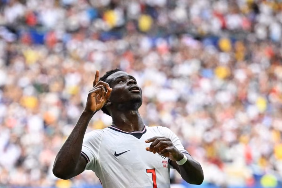 England's forward #07 Bukayo Saka celebrates scoring his team's fourth goal during the 2026 World Cup football tournament third-place match between France and England at the Miami Stadium in Miami on July 18, 2026. CHANDAN KHANNA / AFP