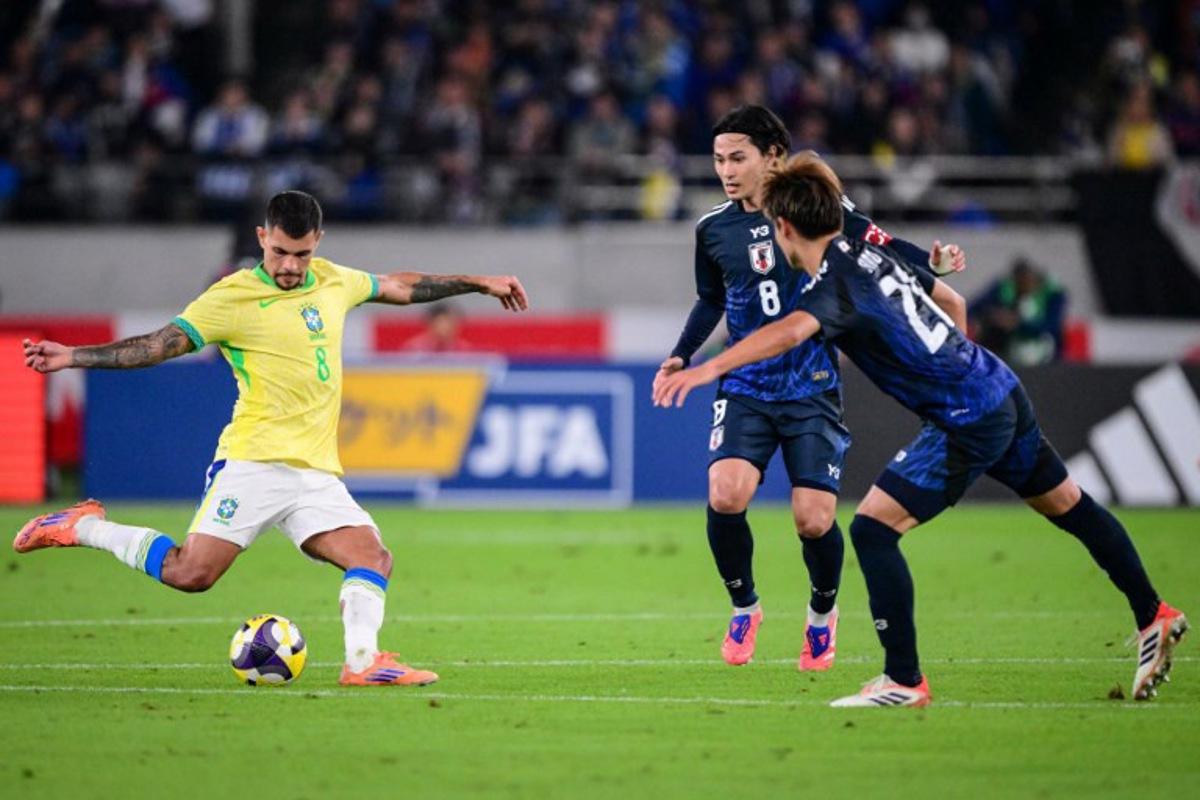 Brazil's midfielder Bruno Guimaraes (L) kicks the ball during the international football friendly match between Japan and Brazil at the Tokyo stadium in Chofu, Tokyo prefecture on October 14, 2025. Yuichi YAMAZAKI / AFP