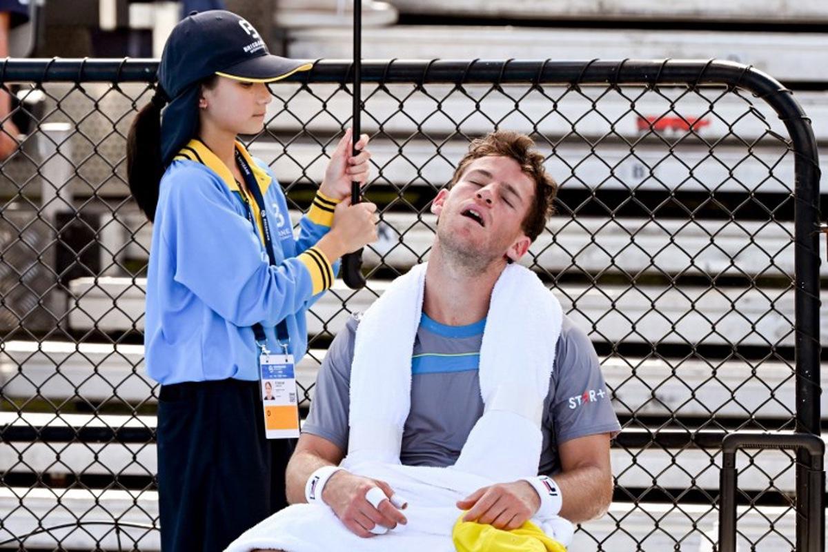 Argentina's Diego Schwartzman (R) rests at a change of ends during his men's singles match against USA's Alex Michelsen at the Brisbane International tennis tournament in Brisbane on December 31, 2023. William WEST / AFP