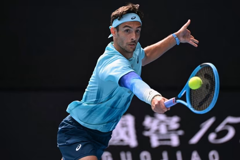 Italy's Lorenzo Musetti hits a return to Serbia's Novak Djokovic during their men's singles quarter-final match on day eleven of the Australian Open tennis tournament in Melbourne on January 28, 2026. WILLIAM WEST / AFP