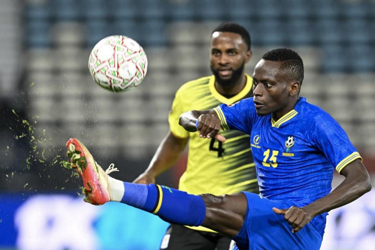 Uganda's defender #04 Kenneth Semakula and Tanzania's defender #15 Mohamed Hussein vie during the Africa Cup of Nations (CAN) Group C football match between Uganda and Tanzania at Al Medina Stadium in Rabat on December 27, 2025. SEBASTIEN BOZON / AFP