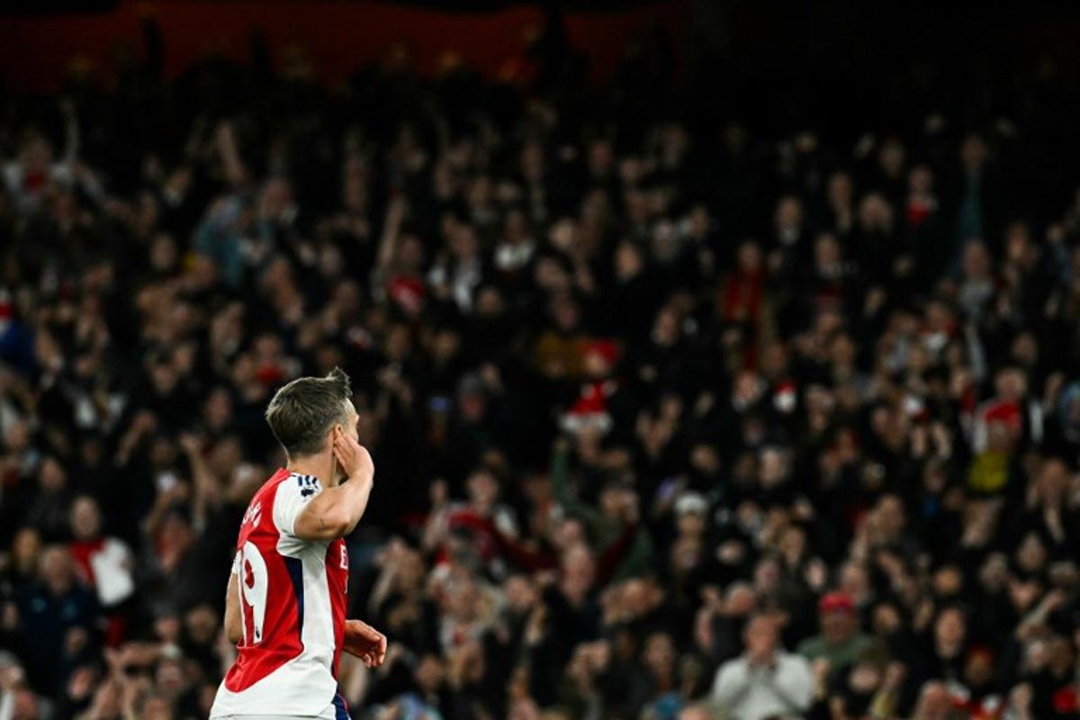 Arsenal's Belgian midfielder #19 Leandro Trossard celebrates after scoring his team second goal during the English Premier League football match between Arsenal and Crystal Palace at the Emirates Stadium in London on April 23, 2025. Ben STANSALL / AFP