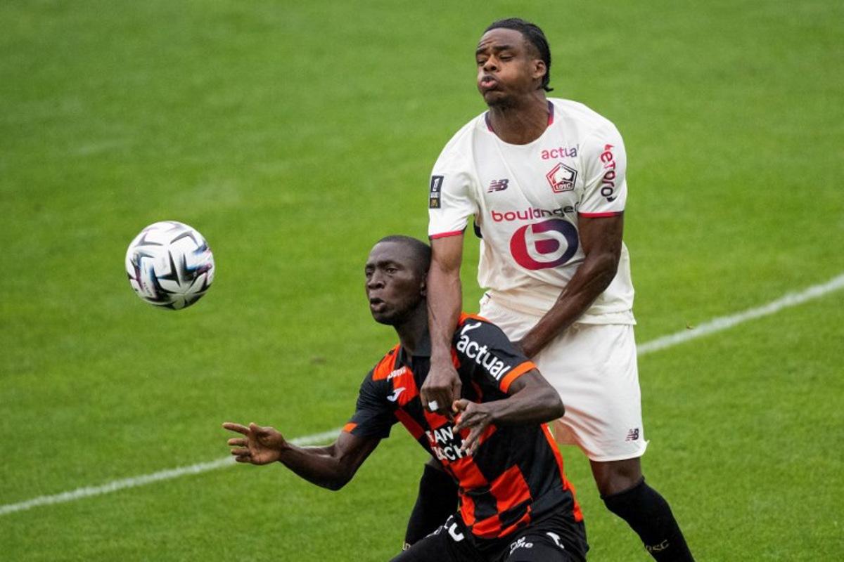 Lorient's Senegalese forward #28 Sambou Soumano (C) fights for the ball with Lille's Belgian defender #03 Nathan Ngoy (R) during the French L1 football match between FC Lorient and lille OSC at Yves-Allainmat stadium in Lorient, western France on August 30, 2025. Loic VENANCE / AFP